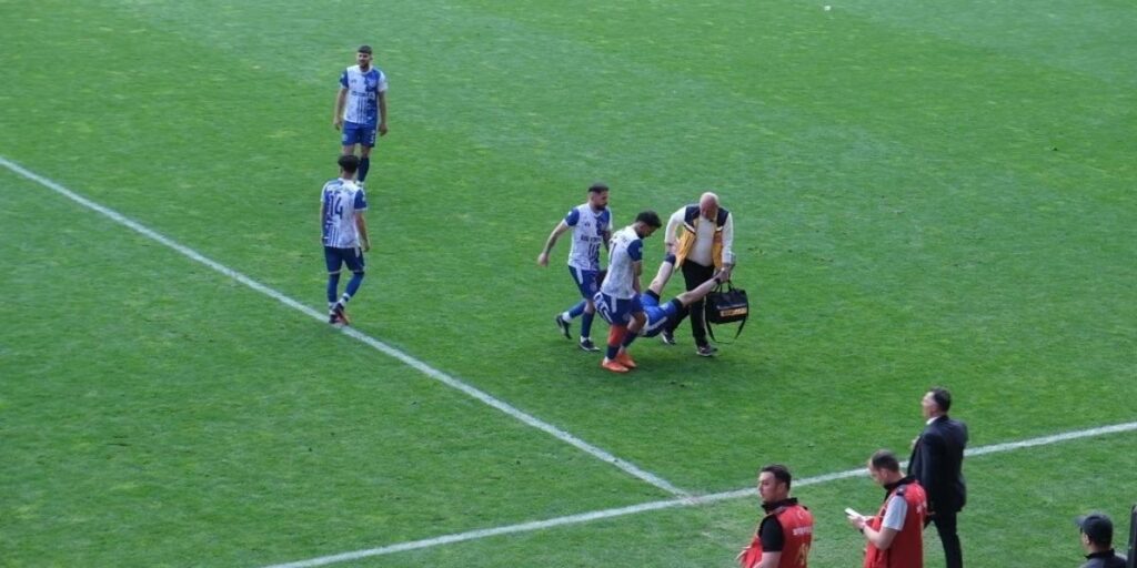Sedye olmayınca sakatlanan futbolcu karga tulumba saha kenarına taşındı